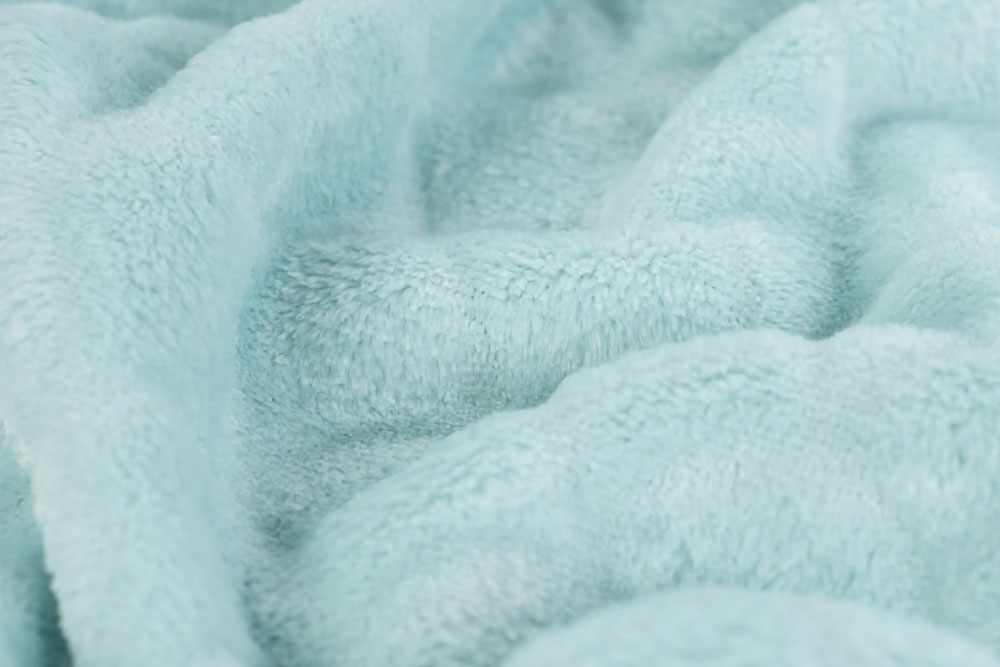 Weicher Fleece in Mint mit geprägtem Schuppenmuster – ideal für Decken, Kissen, Kinderbekleidung und kreative Nähideen. Fl5197 Meerjungfrauenfleece Mint Fasnacht Stoffe Einfarbig Meerjungfrauen-Fleece - Mint